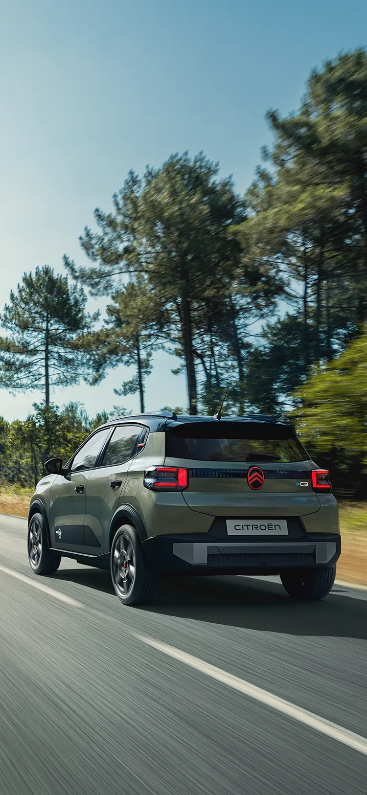 Rear three-quarter view Citroën C3 Outdoor with LED taillights shows Advanced Comfort SUV on open road