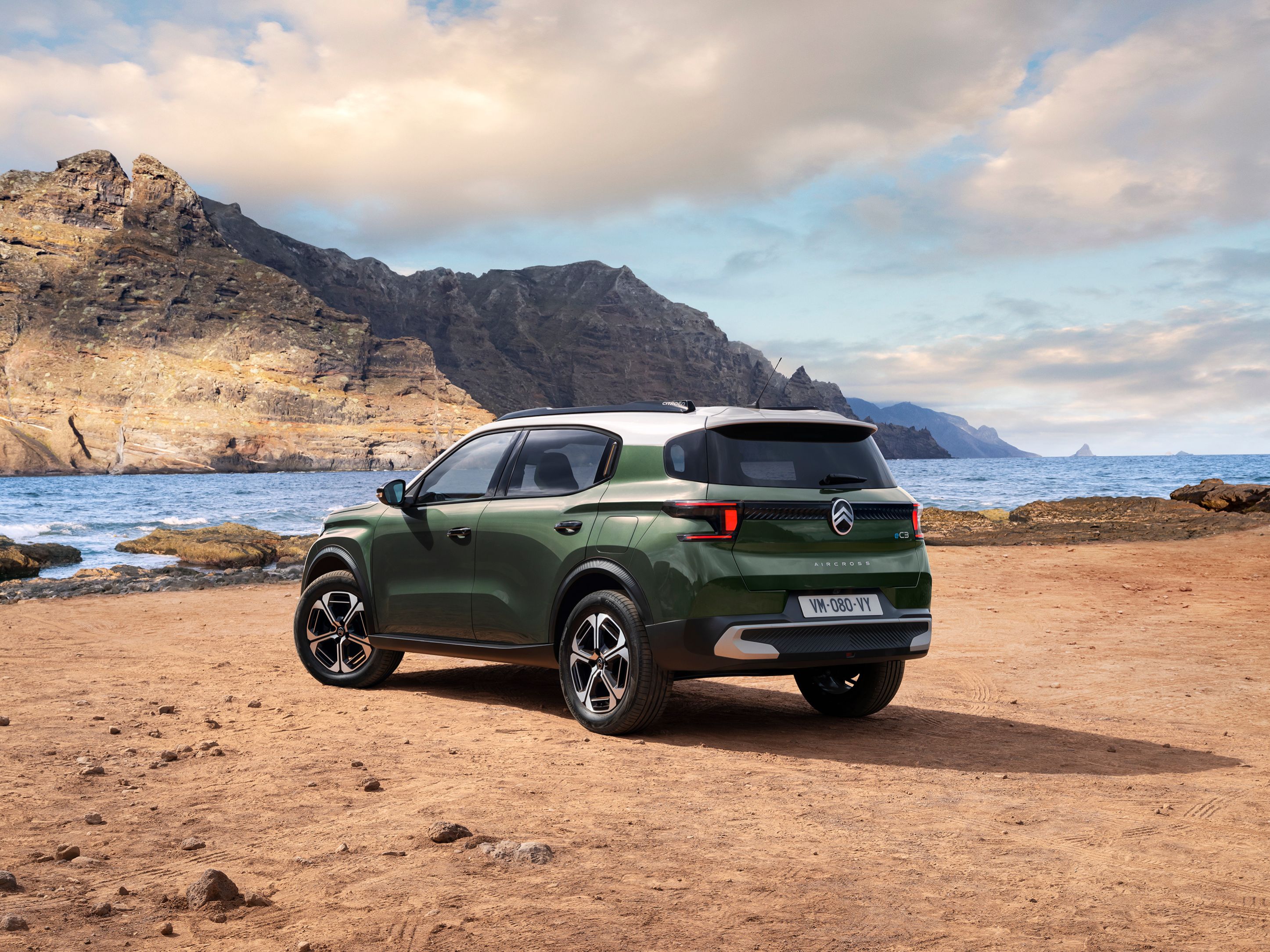 Rear three‑quarter seaside view of Citroën ë-C3 Aircross SUV showcasing modern SUV design for versatile and affordable mobility.